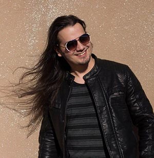 Native American man in leather jacket with hair blowing in mind